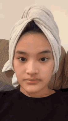 a young woman with a towel wrapped around her head