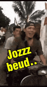 a man riding a scooter with the words jozz beud on the side