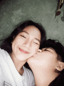 a boy kissing a girl on the cheek