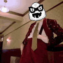a man in a red suit and tie with a pixelated face on his head