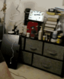 a blurred image of a room with drawers and a bottle of aquafina