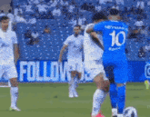 a soccer player wearing a blue jersey with the number 10 on it