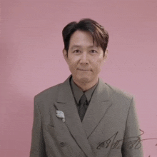 a man in a suit has a signature on his jacket with the number 29 on it