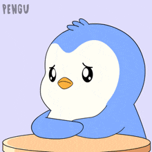 a blue and white penguin is sitting at a table with the word pengu written on the bottom