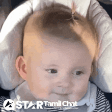 a baby is sitting in a car seat with a star tamil chat logo behind it