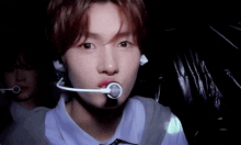 a close up of a person 's face with a microphone in their mouth and a key in the background