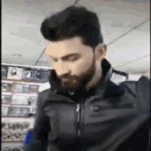 a man with a beard wearing a black jacket
