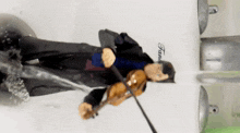 a figurine of a man playing a violin in front of a tank