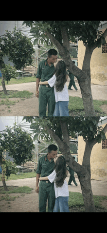 a man and a woman kissing under a tree in a park