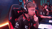 a man wearing headphones with logitech written on the sleeve