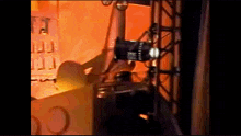 a blurred image of a stage with a spotlight and a sign that says ' o '