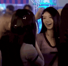a woman with a star in her hair laughs with another woman