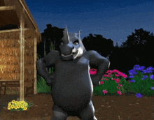a rhino is standing with his hands on his hips in a garden