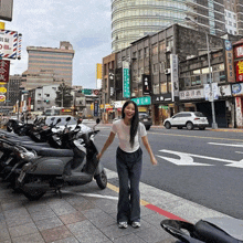 a woman stands in front of a row of scooters with a sign that says ' barber shop ' on it