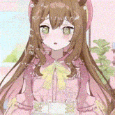 a girl with long brown hair and green eyes is wearing a pink dress and holding a box .