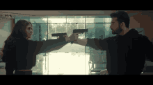 a man and a woman are pointing guns at each other with a vprl logo on the bottom