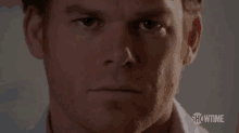 a close up of a man 's face looking at the camera .