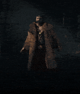 a man with a beard wearing a fur coat in the dark