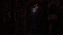 a man with a bow and arrow is standing in a dark room