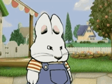 a cartoon rabbit wearing overalls and a striped shirt is standing on a sidewalk