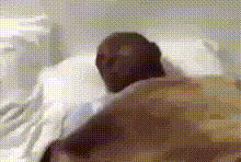 a man is laying in a hospital bed with his head on the pillow