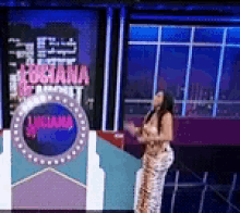a woman stands in front of a sign that says obama