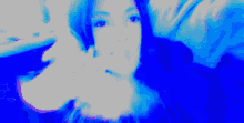 a blurry picture of a woman covering her face with her hands