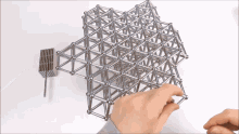 a person is playing with a set of magnetic balls