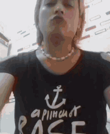 a woman wearing a black t-shirt that says a pinch of race