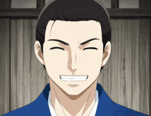 a man with a ponytail and a blue shirt smiles with his eyes closed