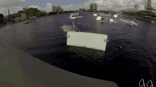 a person is doing a trick in the water with the letters aa visible in the foreground