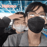a man and a woman wearing face masks and glasses with the word helooo above them