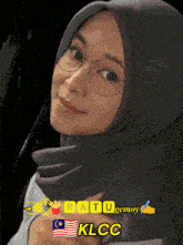 a woman wearing glasses and a hijab with the words ratu gemoy klcc below her