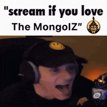 a man wearing headphones and a hat is screaming with the words `` scream if you love the mongolz '' .