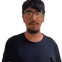 a man with glasses and a beard wearing a blue shirt