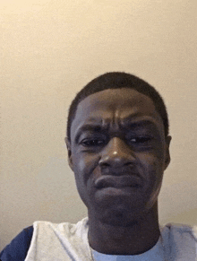 a young man is making a funny face with his eyes closed