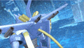 a blue and gold robot with a few guns on its back