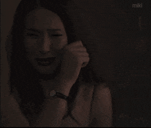 a painting of a woman crying with the word miki on the bottom