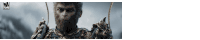 a man with a beard is holding a sword with the letter m on the bottom