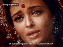 a close up of a woman 's face with a red dot on her forehead and a question .