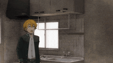 a man in a black jacket stands in a kitchen
