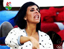 a woman is sitting on a couch with her mouth open