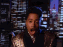 a man in a suit and tie is making a surprised face
