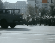 a group of soldiers marching down a street with a sign that says ' a ' on it