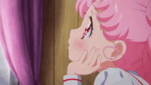 a little girl with pink hair is looking out a window