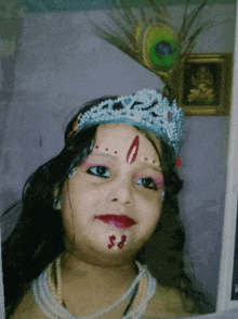 a little girl with a peacock feather on her head and a crown on her head