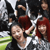 a girl with red hair is laughing with another girl