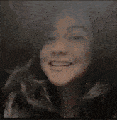 a close up of a woman 's face smiling