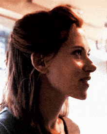 a close up of a woman 's face with her hair in a half up half down hairstyle