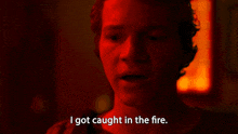 a man in a red light is saying i got caught in the fire